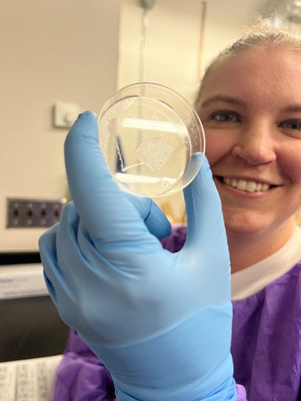 A close up of Haley showing a petri dish.
